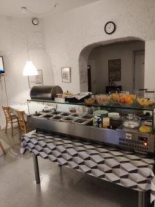 a kitchen with a counter with food on it at Hotelli Merikotka in Kotka