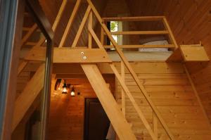 a loft bed in a wooden cabin at Paradiso Mestia in Mestia