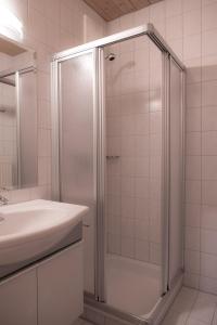 a bathroom with a shower and a sink at Die Pension - Margreiter in Saalbach-Hinterglemm