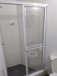 a shower with a glass door in a bathroom at Costa del Llano Hotel Campestre in Villavicencio