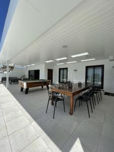 a dining room with a table and a pool table at VillaMare in Puerto del Carmen