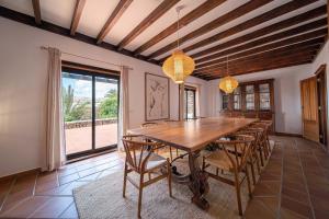 a dining room with a wooden table and chairs at VillaMare in Puerto del Carmen