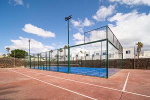 a tennis court with a net on a tennis court at VillaMare in Puerto del Carmen