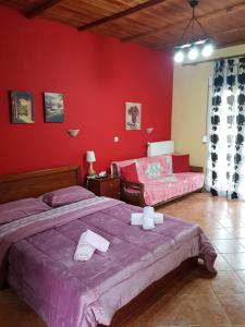 A bed or beds in a room at Alexandros Guesthouse