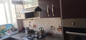 a kitchen with a stove and a counter top at Maison de la famille in Casablanca