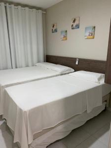 Кровать или кровати в номере Muro Alto Condomínio Clube Apt 316 +20 фотографий