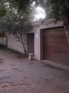 a garage with a garage door and a building at Sasha guest house in Johannesburg