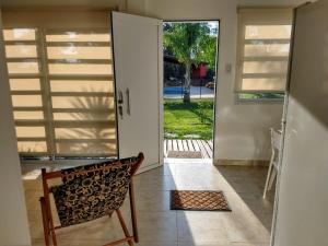 a door leading into aoyer with a bench and a door leading to a patio at Apart del YERUA in Puerto Yeruá