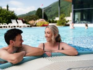 un hombre y una mujer en la piscina en Hotel Alexandra Loen en Loen