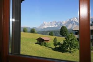 a view of a mountain from a window at Wellness-Pension Jagahütt'n in Schladming