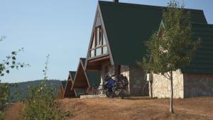 a motorcycle parked in front of a house at Etno selo Izlazak in Rudinice