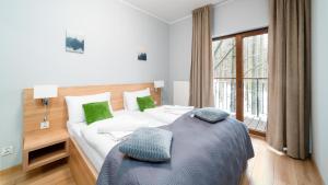 Posteľ alebo postele v izbe v ubytovaní Apartamenty Sun & Snow Resort Karkonosze