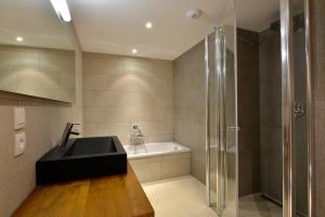 a bathroom with a sink and a shower at Oasis Les Portes du Soleil Mountain Resort in La Chapelle-dʼAbondance