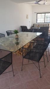 a large wooden table with chairs around a living room at ACAPULCO DIAMANTE NUEVA E INCREIBLE VILLA CON ALBERCA PROPIA in Acapulco
