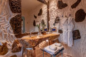 a bathroom with a sink, a mirror, and a table at Calilo in Manganari