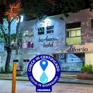 a blue and white sign in front of a building at Hotel Barbacoa Uraba in Apartadó