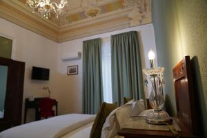 a bedroom with a bed and a candle on a table at DS Apartment in Catania