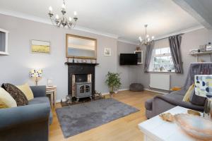 a living room with a couch and a fireplace at Finest Retreats - Poppy Cottage in Docking