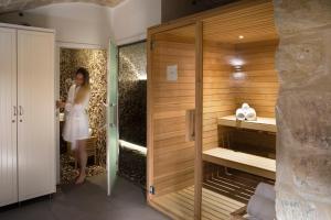 a woman standing in a room with a sauna at Hôtel R de Paris - Boutique Hotel in Paris +43 photos