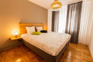 1 dormitorio con 1 cama grande con almohada amarilla en Cosy 2-bedroom flat - Fully equipped en Reşiţa