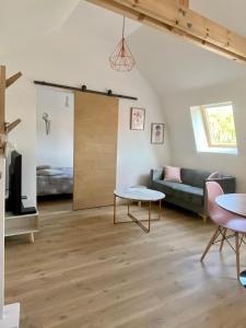 a living room with a couch and a table at Appartements du 101 in Villeneuve d'Ascq