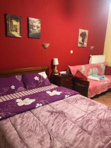 A bed or beds in a room at Alexandros Guesthouse