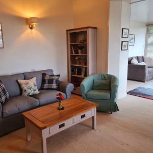 a living room with two couches and a coffee table at Atholl House Skye in Dunvegan