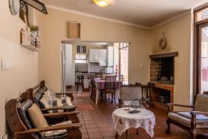 a living room filled with furniture and a fireplace at Bay Vista Guesthouse in Mossel Bay