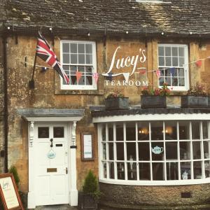 a building with a flag in front of it at Lucy's Tearoom in Stow on the Wold