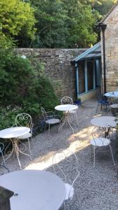a group of tables and chairs in front of a building at Lucy's Tearoom in Stow on the Wold