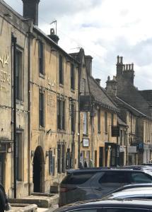 a row of buildings on a street with parked cars at Lucy's Tearoom B&B in Stow on the Wold +29 photos