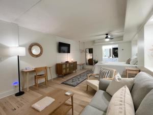 a living room with a couch and a bed at Just Shy of the Bridge - Waterway Condo 110 in Wilmington