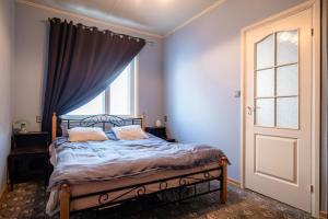 a bedroom with a bed with two pillows and a window at Campenhausen lodging in the heart of Kuressaare in Kuressaare +9 photos