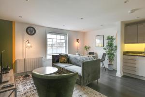 a living room with a couch and a table at Beautiful Chelmsford Apartment in Chelmsford