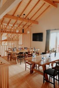 a large room with wooden tables and chairs at Domaine Etxezahar in Bardos
