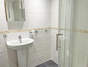 a bathroom with a sink and a shower at The President Hotel in Blackpool