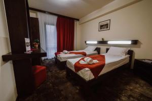 a hotel room with two beds and a window at Hotel Relax & Resort Sovata in Sovata +80 photos