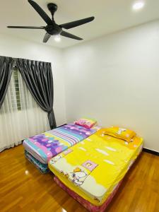 a bed in a room with a ceiling fan at Shuang Yang Sekinchan Homestay 3 in Sekincan +12 photos