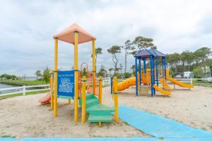 a playground with a slide in the sand at Sun Outdoors Ocean City in Ocean City