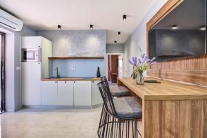 a kitchen with a table and chairs and a refrigerator at Luxury apartments in Mali Lošinj