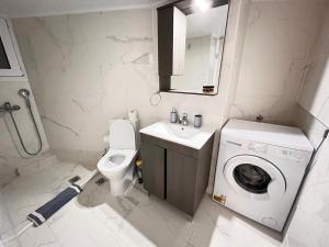 ein kleines Bad mit einer Waschmaschine und einer Waschmaschine in der Unterkunft Acropolis Select Flat in Athen