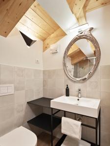 a bathroom with a sink and a mirror at Crocevia - Locanda carsica contemporanea in Trieste