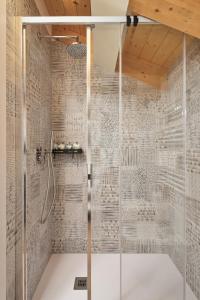 a shower with a glass door in a bathroom at Crocevia - Locanda carsica contemporanea in Trieste
