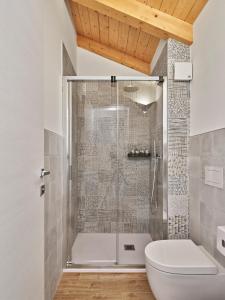 a bathroom with a shower and a toilet at Crocevia - Locanda carsica contemporanea in Trieste +37 photos