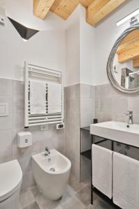 a white bathroom with a sink and a toilet at Crocevia - Locanda carsica contemporanea in Trieste