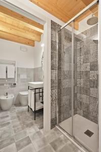 a bathroom with a shower and a sink and a toilet at Crocevia - Locanda carsica contemporanea in Trieste
