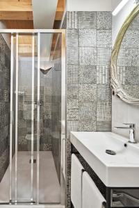 a bathroom with a sink and a shower at Crocevia - Locanda carsica contemporanea in Trieste