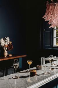 a table with glasses of wine on a counter at Killiecrankie House in Pitlochry