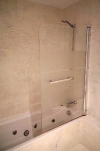 a shower with a glass door in a bathroom at Moderne Ferienwohnung Primavera in Colonia Sant Jordi