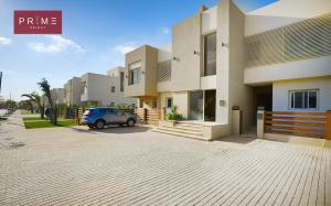 a car parked in front of a house at Prime Select Palm Hills - The Crown in Abū Rawwāsh